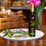 200 ml bottle of Herbs de Provence Olive oil on white plate with herbs and sample of olive oil