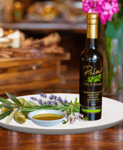 200 ml bottle of Herbs de Provence Olive oil on white plate with herbs and sample of olive oil