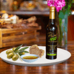 A 200ml bottle of White Truffle Oil on white plate with truffle and sample olive oil