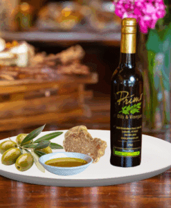 A 200ml bottle of White Truffle Oil on white plate with truffle and sample olive oil