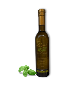A 375ml bottle of Basil Olive Oil with basil leaves.