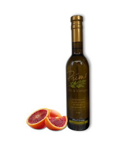 A 375ml bottle of Blood Orange Olive Oil with blood oranges.