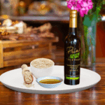 A 200ml of Toasted Sesame Seed Oil on white plate with a bowl of sesame seeds and sample of oil