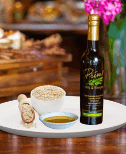 A 200ml of Toasted Sesame Seed Oil on white plate with a bowl of sesame seeds and sample of oil