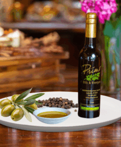 A 200ml bottle of Madagascar Black Pepper on white plate with black peppercorn and sample olive oil