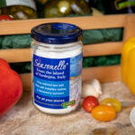 A jar of Seasonello Sea Salt with tomato, garlic, herbs and pepper on side