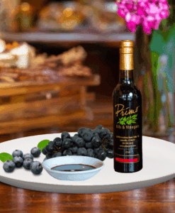 A 200ml bottle of Blueberry Balsamic on white plate with blueberries and sample balsamic vinegar
