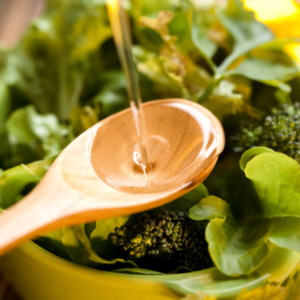 a spoonful of olive oil in a vegetable bowl