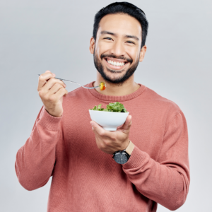 man-smilling-while-eating-healthy-food