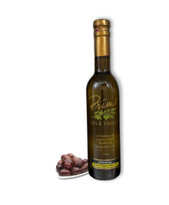 375ml bottle of Arbequina Extra Virgin Olive Oil with plate of olives grown in Chile.