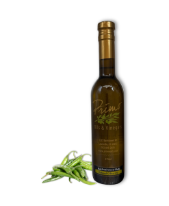 A 375ml bottle of Baklouti Green Chili Olive Oil with green Baklouti chilies.