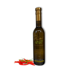 A 375ml bottle of Cayenne Chili Olive Oil with cayenne peppers.