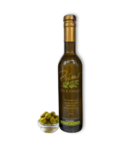 A 375ml bottle of Coratina Extra Virgin Olive Oil with bowl of green olives grown in Italy.