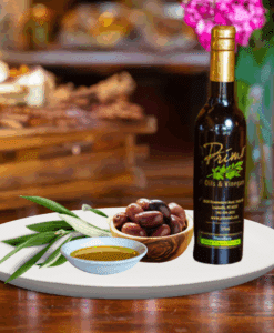 A 200ml bottle of Picual Extra Olive Oil on white plate with a bowl of purple olives from Chile and sample olive oil