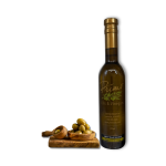A 375ml bottle of Olive Wood Smoked Olive Oil with green olives on a wooden board.