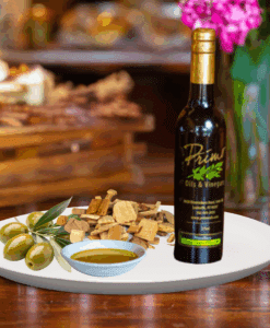 A 200ml bottle of Olive Wood Smoked Olive Oil on white plate with olive wood and sample olive oil