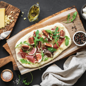 Pizza with Figs, Prosciutto, Carmelized Onions, Fig Balsamic and Arugula 